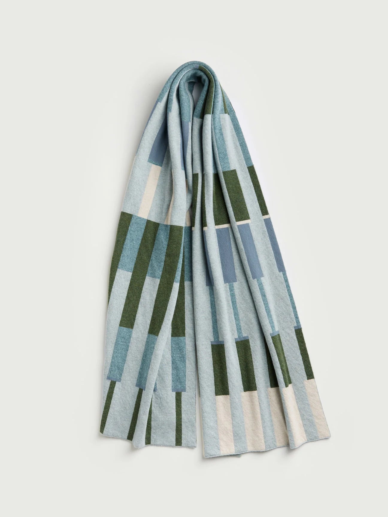 Folded scarf with geometric pattern on a light gray background