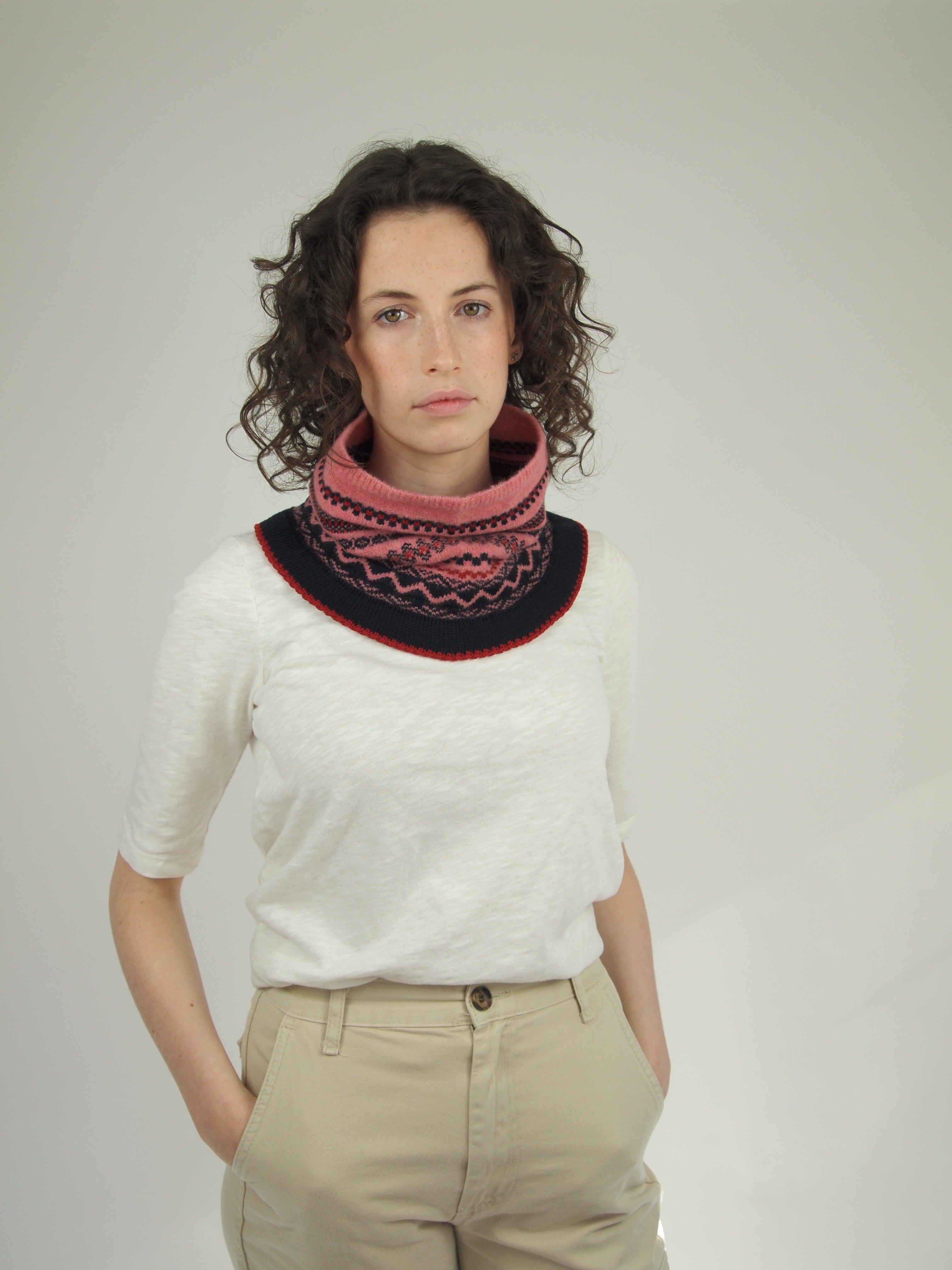 Pink and navy blue knitted cowl neck warmer with a Fair Isle-style pattern.