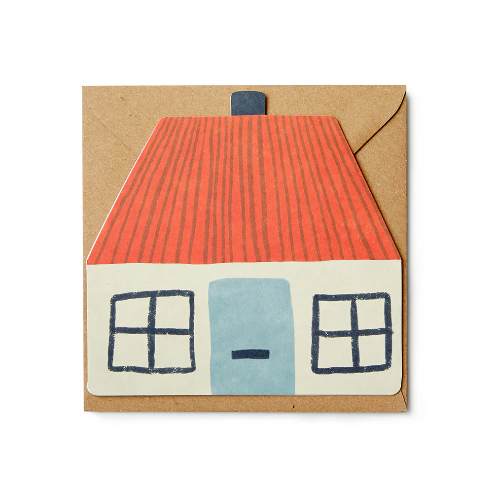 A paper envelope featuring a house design with a red roof, blue door, and cream walls. Brand: Donna Wilson.