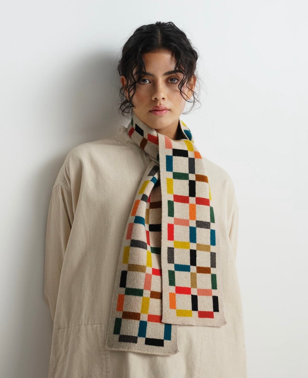 Multicolored geometric patterned wool scarf.  Cream, red, yellow, green, and dark gray squares.