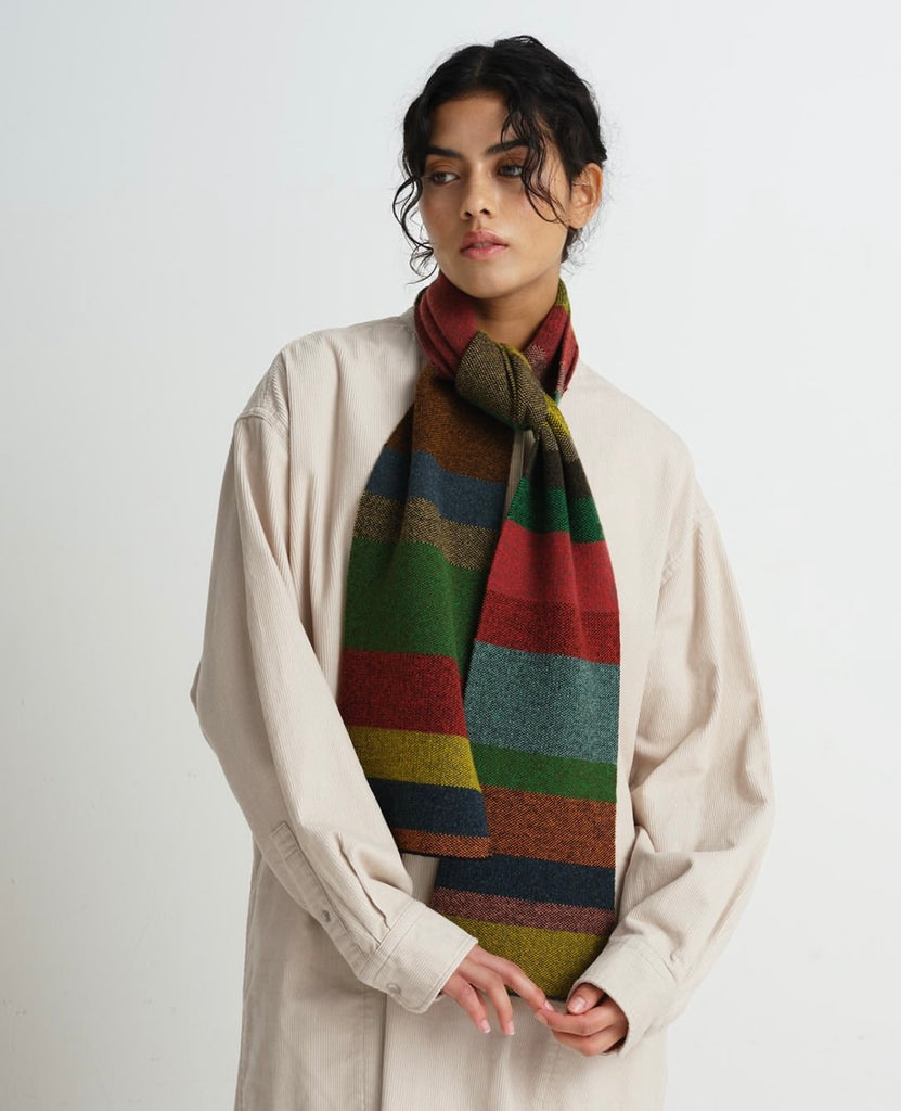 Multicolored striped wool scarf with red, green, and gold tones.