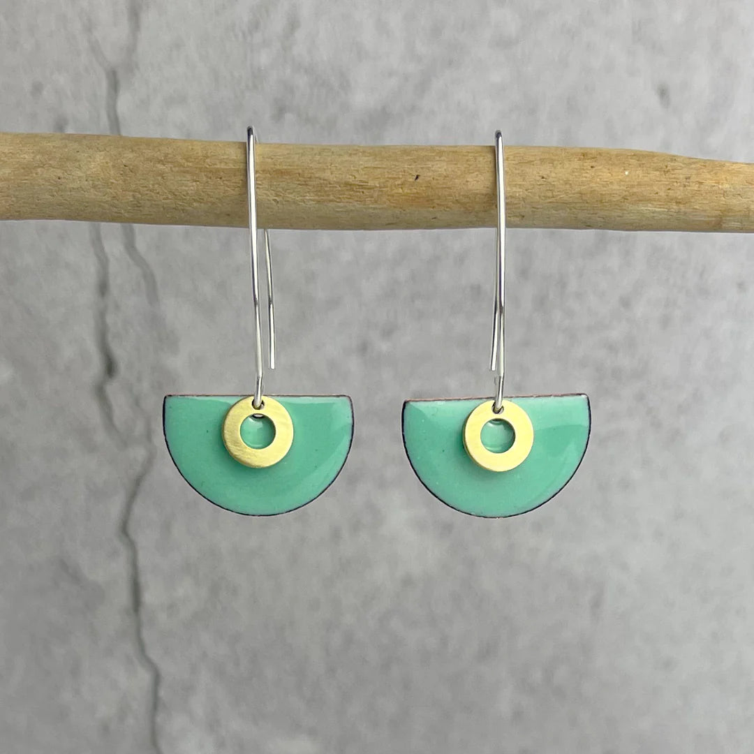 Pair of mint green enamel half-circle earrings with gold rings and silver hooks.