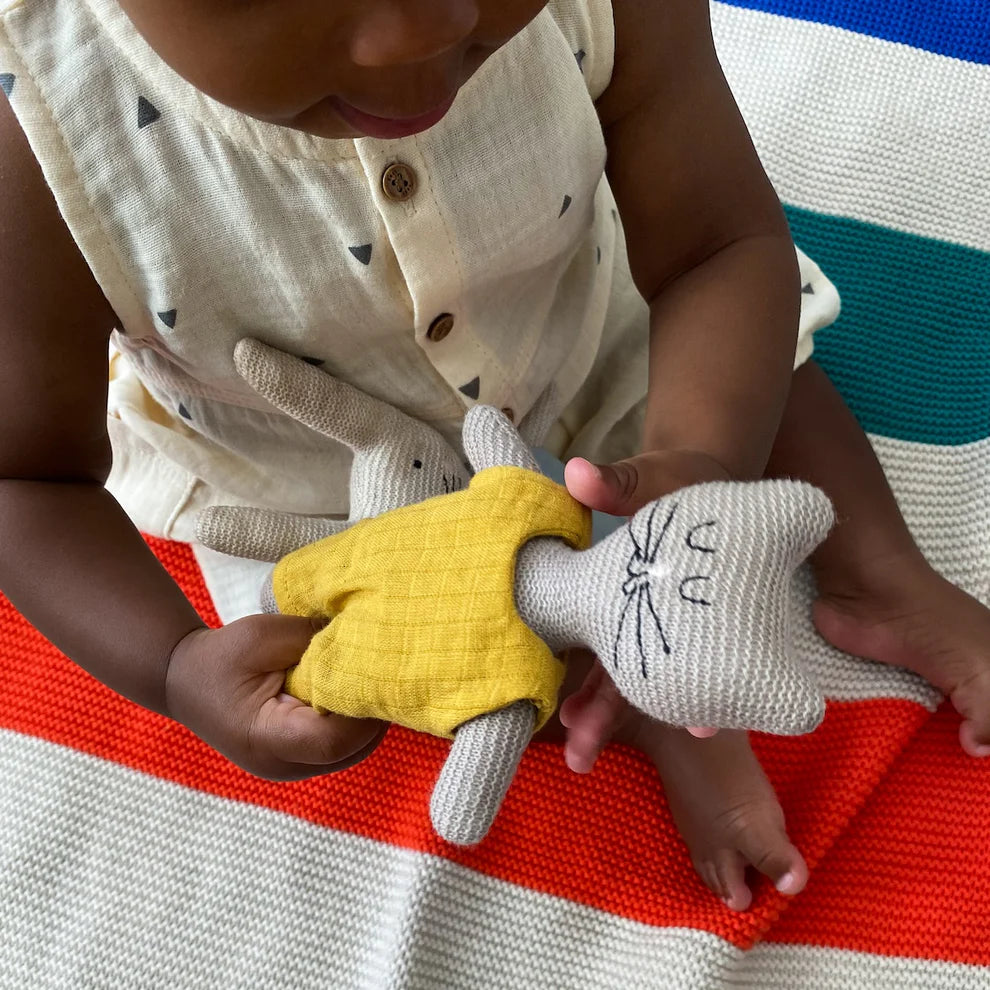 Knitted cat and bunny toys; the cat wears a yellow outfit.