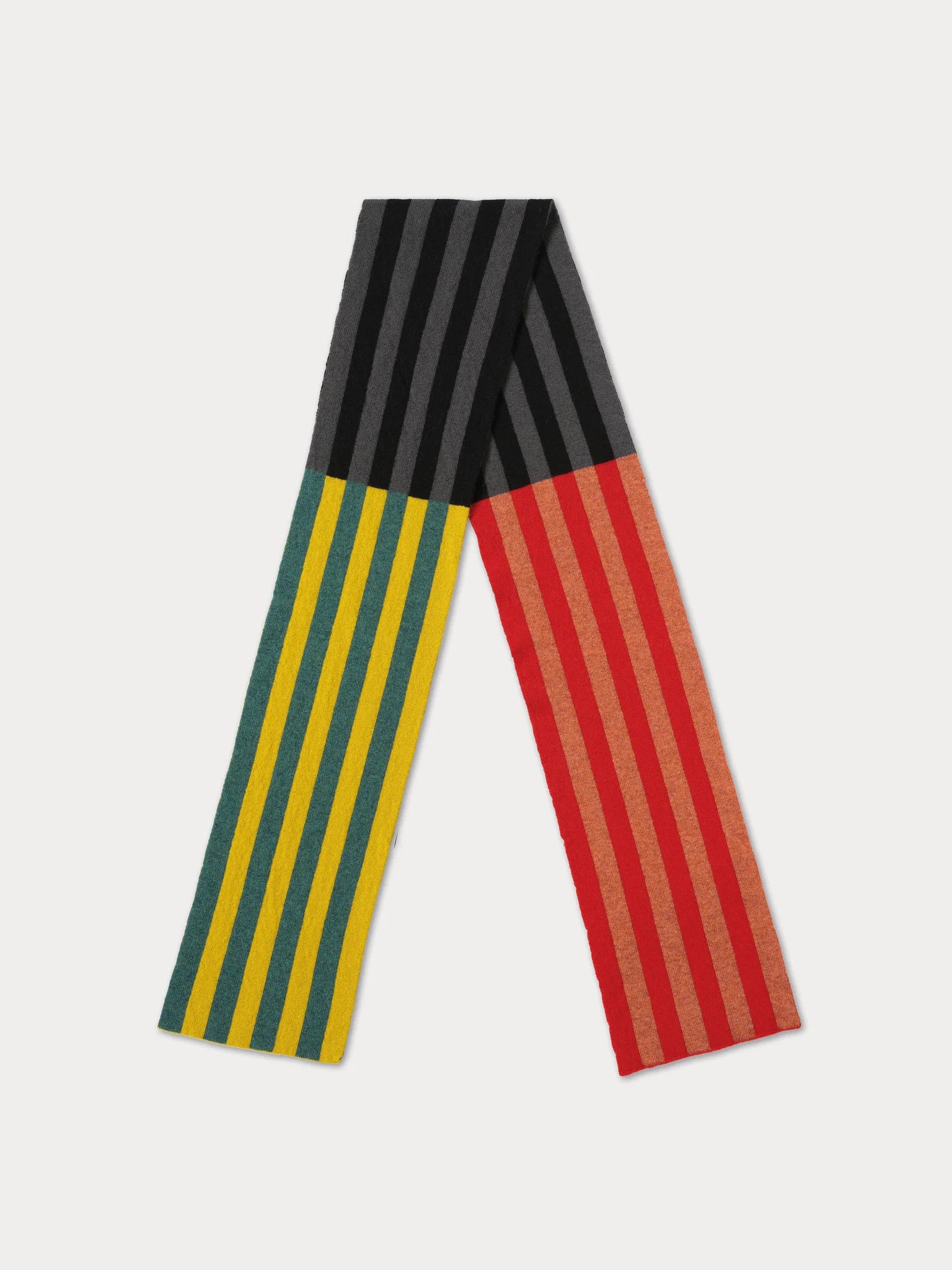 A knit scarf with a geometric color-blocked design featuring vertical stripes in black and gray on the middle section, yellow and green stripes on the left lower section, and red and gold stripes on the right lower section, displayed on a light gray background.