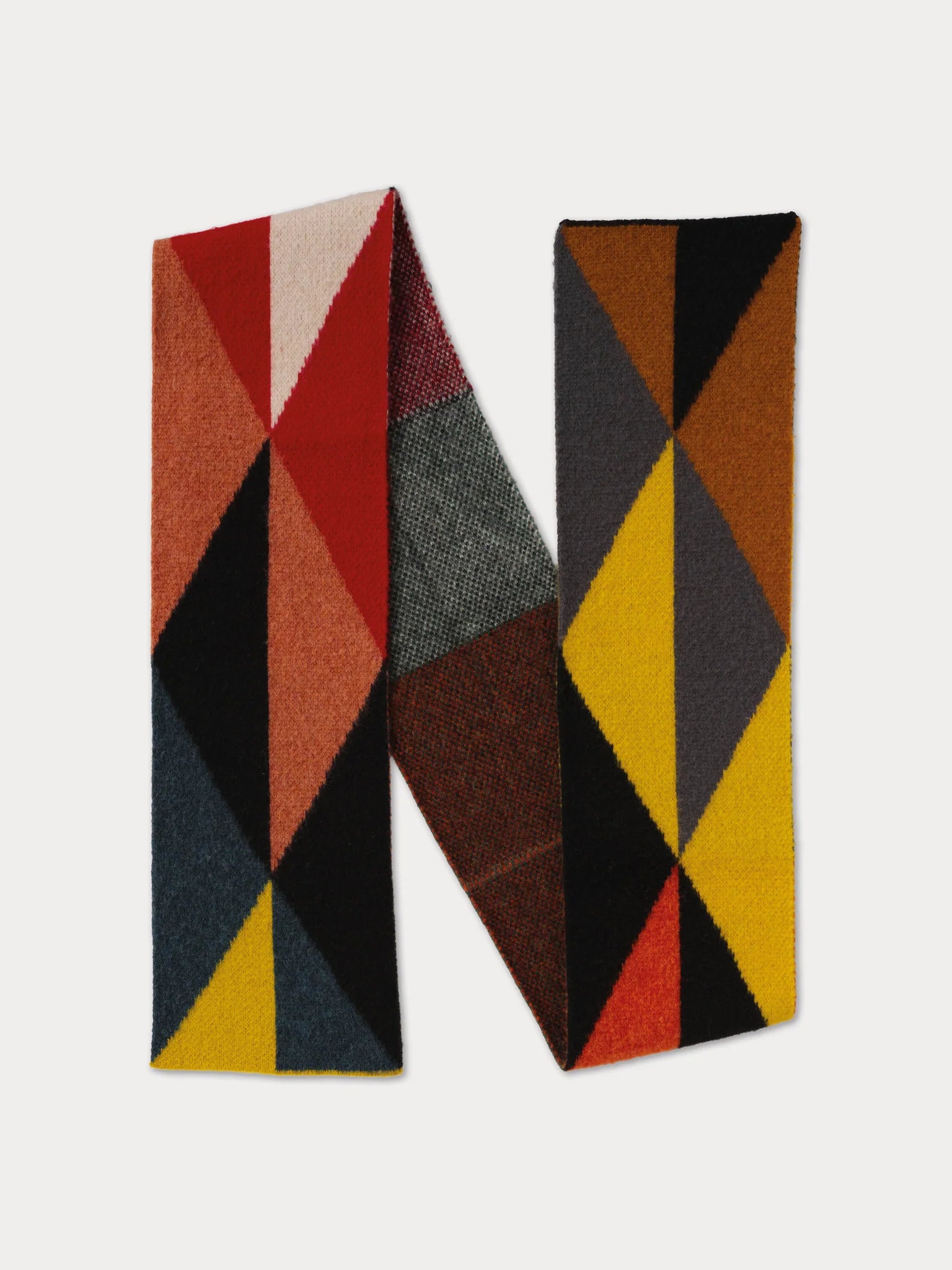 A geometric-patterned scarve in red, brown, yellow, and gray on a light gray background