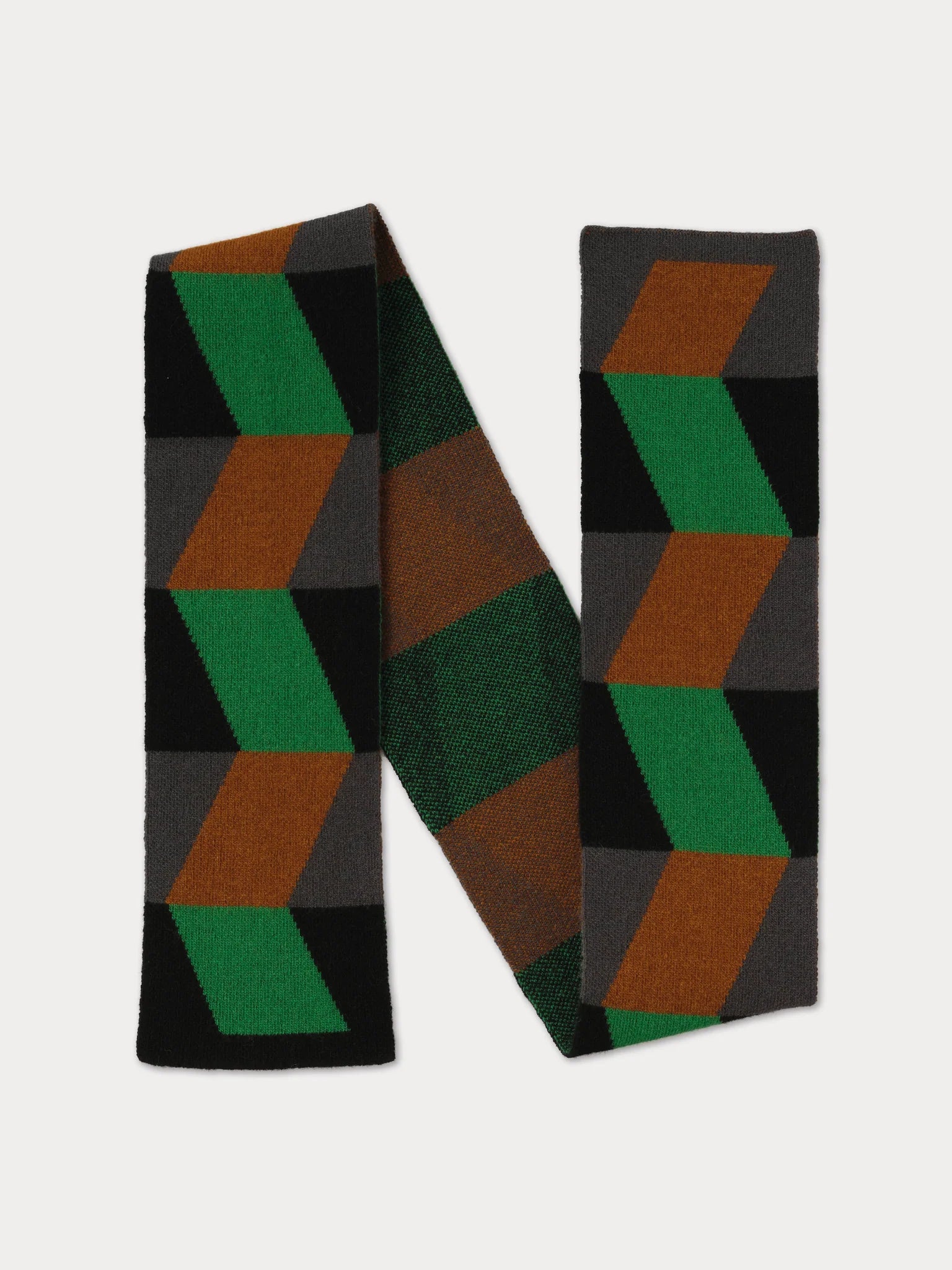 A knit scarf with a geometric 3D-effect chevron pattern in green, brown, and orange on a black background, displayed on a light gray background.