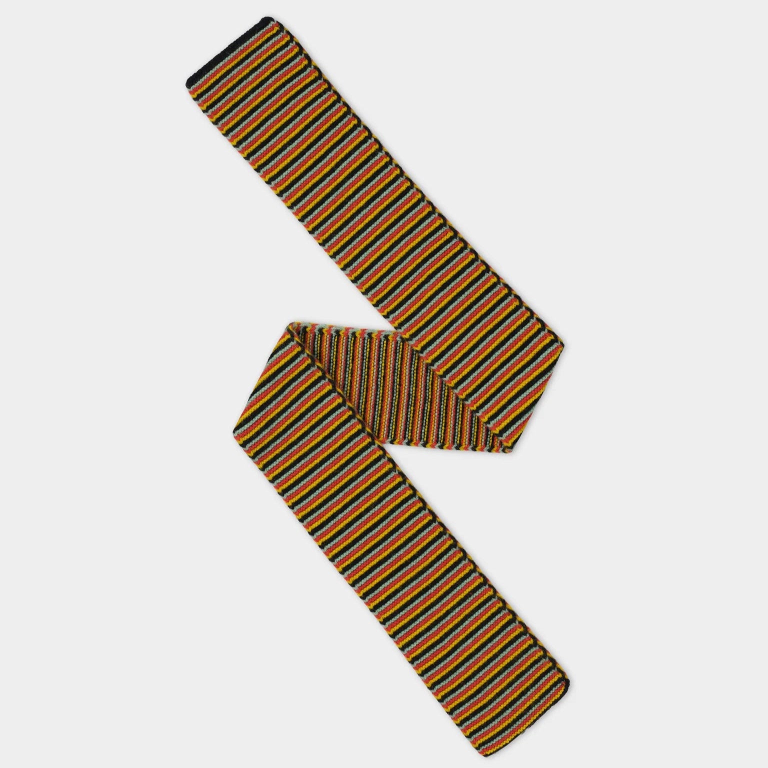 Multicolored striped knitted scarf.  Features orange, black, gray, and yellow stripes.