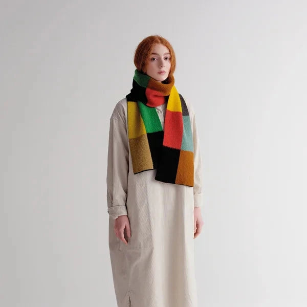 Multicolored wool scarf with a geometric block pattern in shades of green, red, yellow, brown, and black.