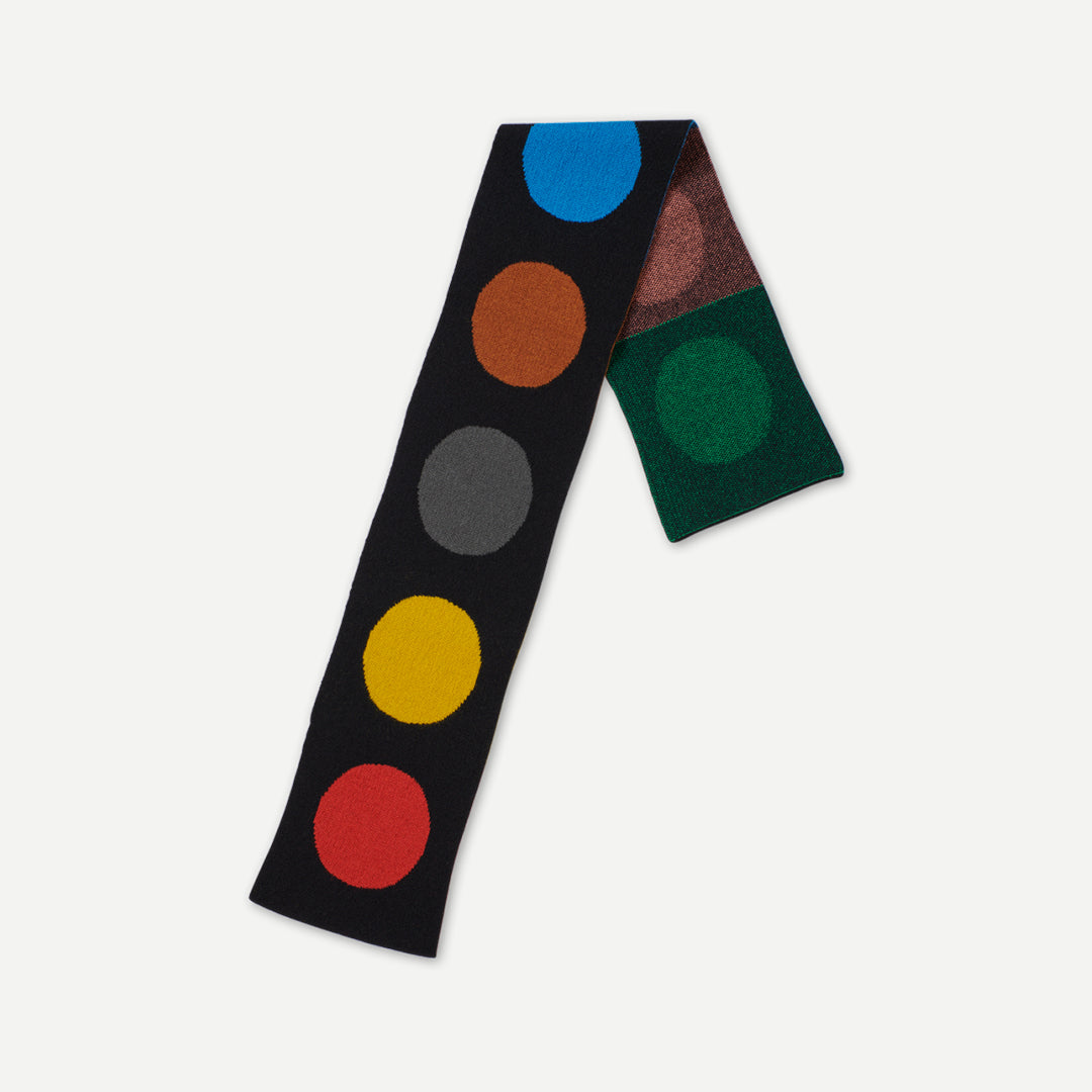 Black knit scarf with multicolored circular pattern.  Features blue, orange, gray, yellow, and red circles.