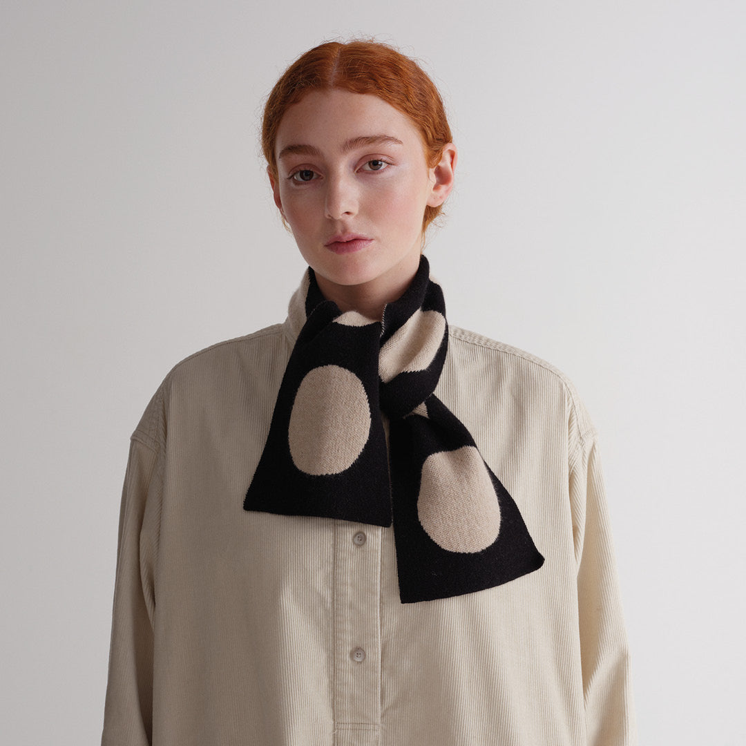 Black and beige polka dot knit scarf.