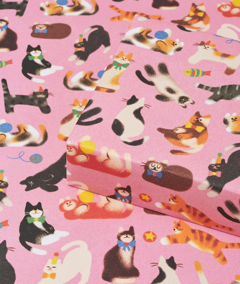 Pink fabric with colorful cat illustrations and small boxes.