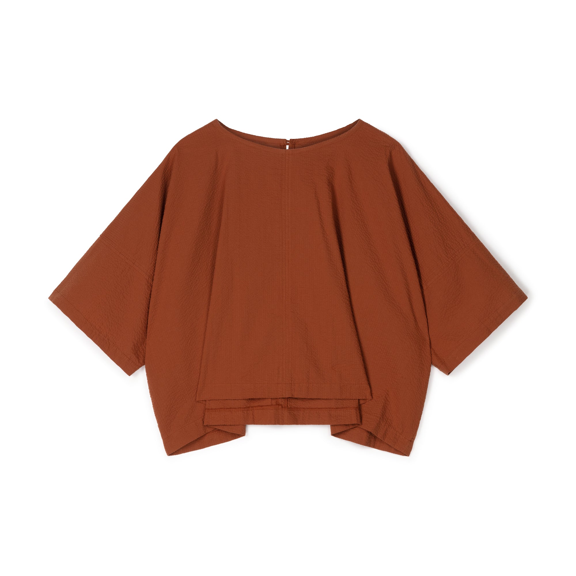 Burnt orange, short-sleeved, boxy top with a textured fabric and a slightly gathered hem.
