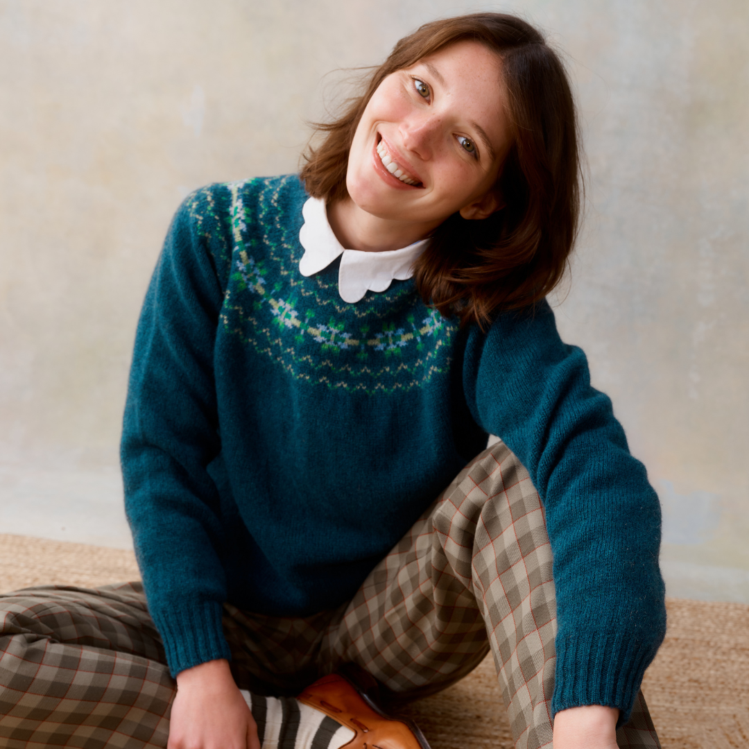 Teal Fair Isle knit sweater with a white Peter Pan collar.