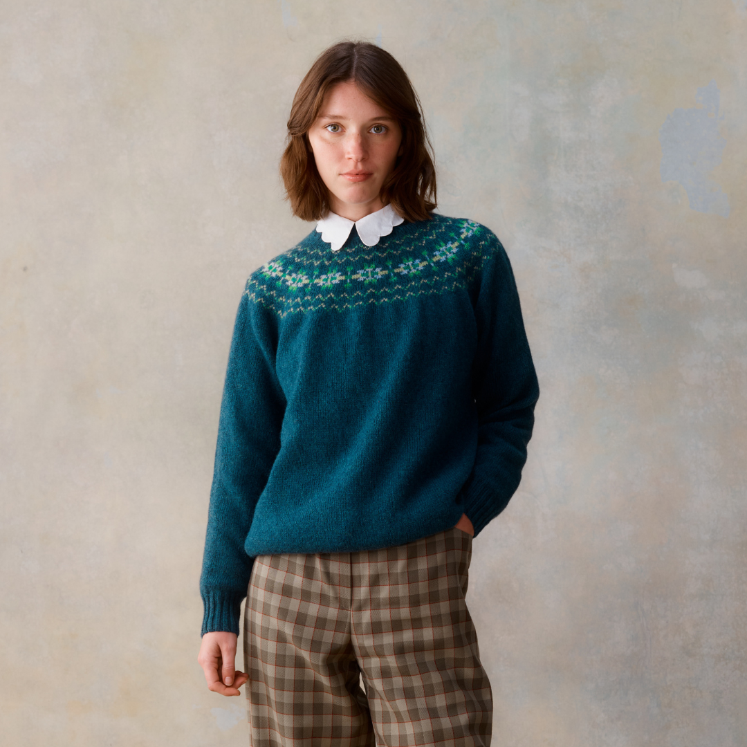 Teal wool sweater with a Fair Isle-style yoke and long sleeves.