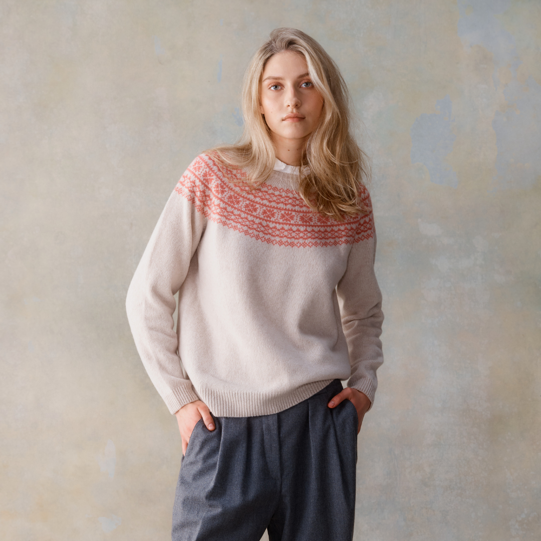 Cream-colored cashmere sweater with a coral-colored Fair Isle yoke.