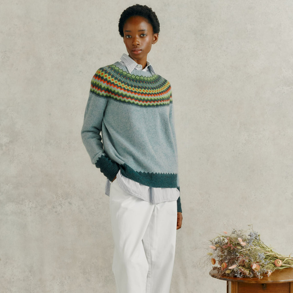 Light blue crewneck sweater with a multicolored Fair Isle-style yoke.