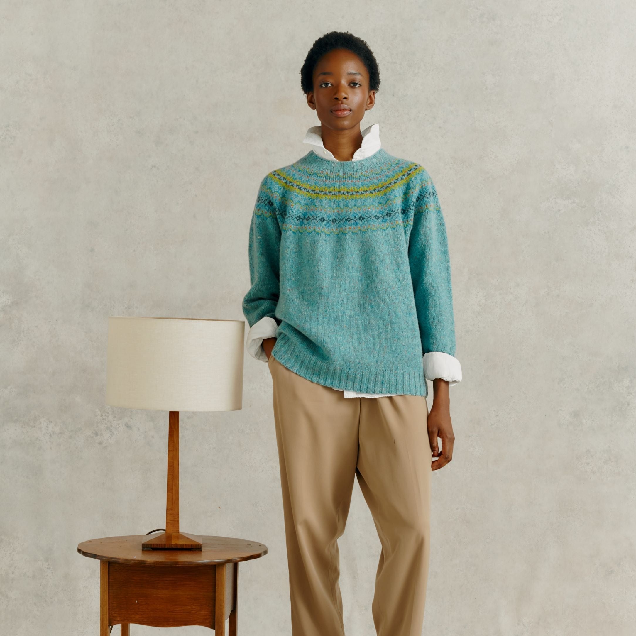 Teal wool sweater with a Fair Isle-style yoke, shown on a model.