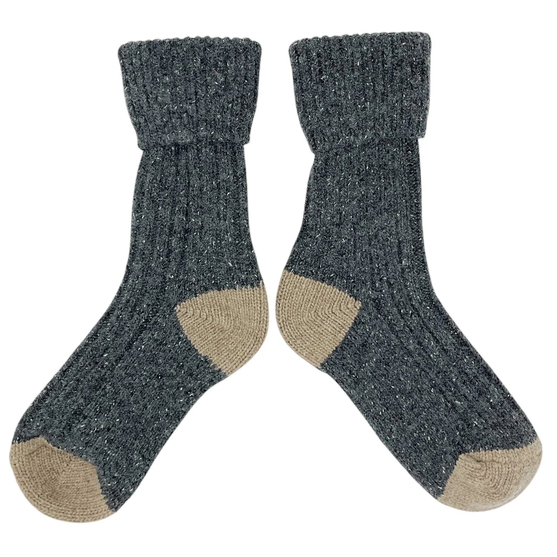 Pair of dark gray socks with beige toes and cuffs on a white background