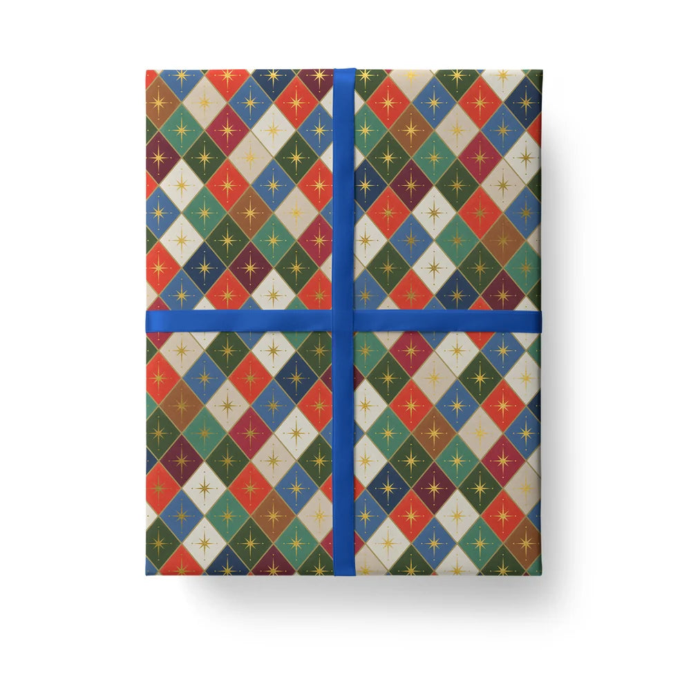 A rectangular gift box wrapped in a multicolor argyle patterned paper with a blue ribbon crossing at the center on a white background.