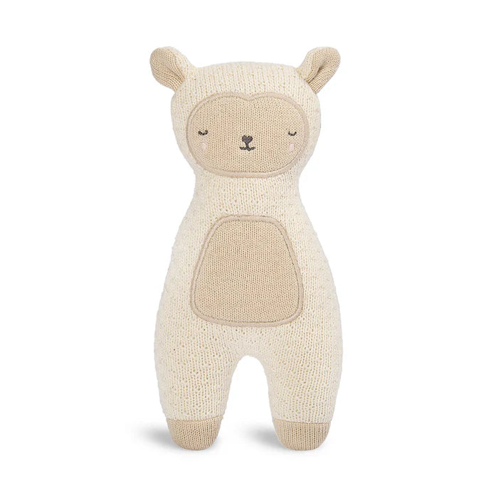 Knitted toy sheep on a white background