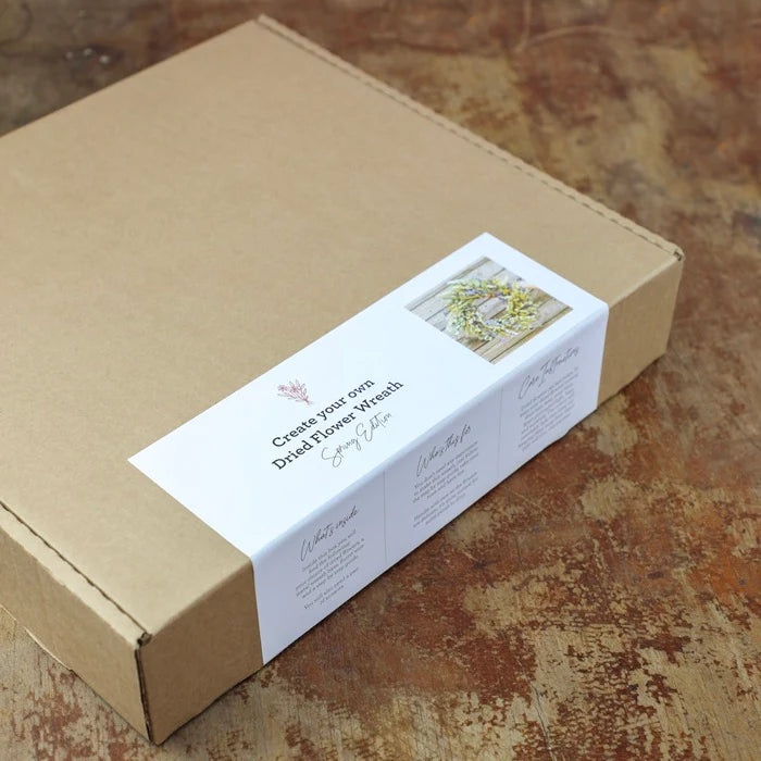 Spring edition dried flower wreath kit in a brown cardboard box.  Label shows a finished wreath example.