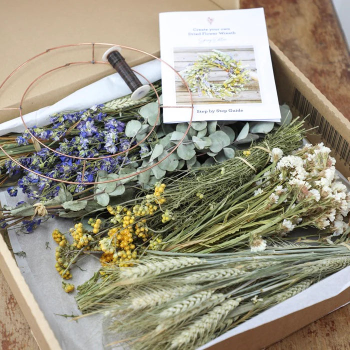Dried flower wreath kit with copper wire ring, dried flowers, foliage, and wheat.