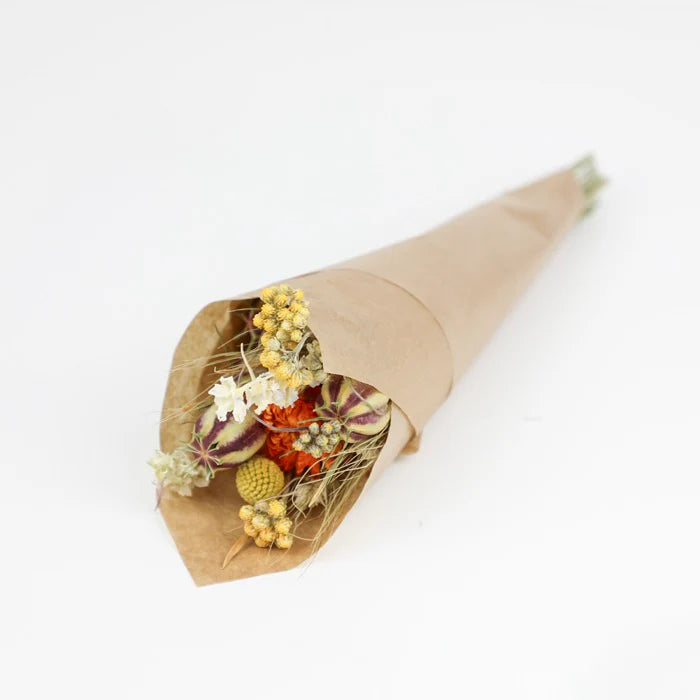 Dried flower bouquet in brown paper wrapping.  Includes yellow, orange, and purple flowers and seed pods.