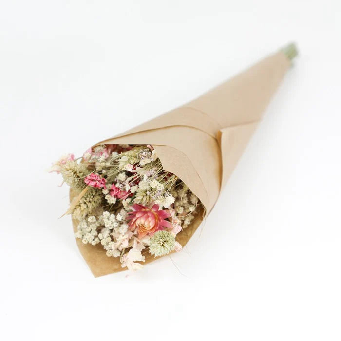 Dried flower bouquet in kraft paper cone.  Pale pink, white, and beige flowers.