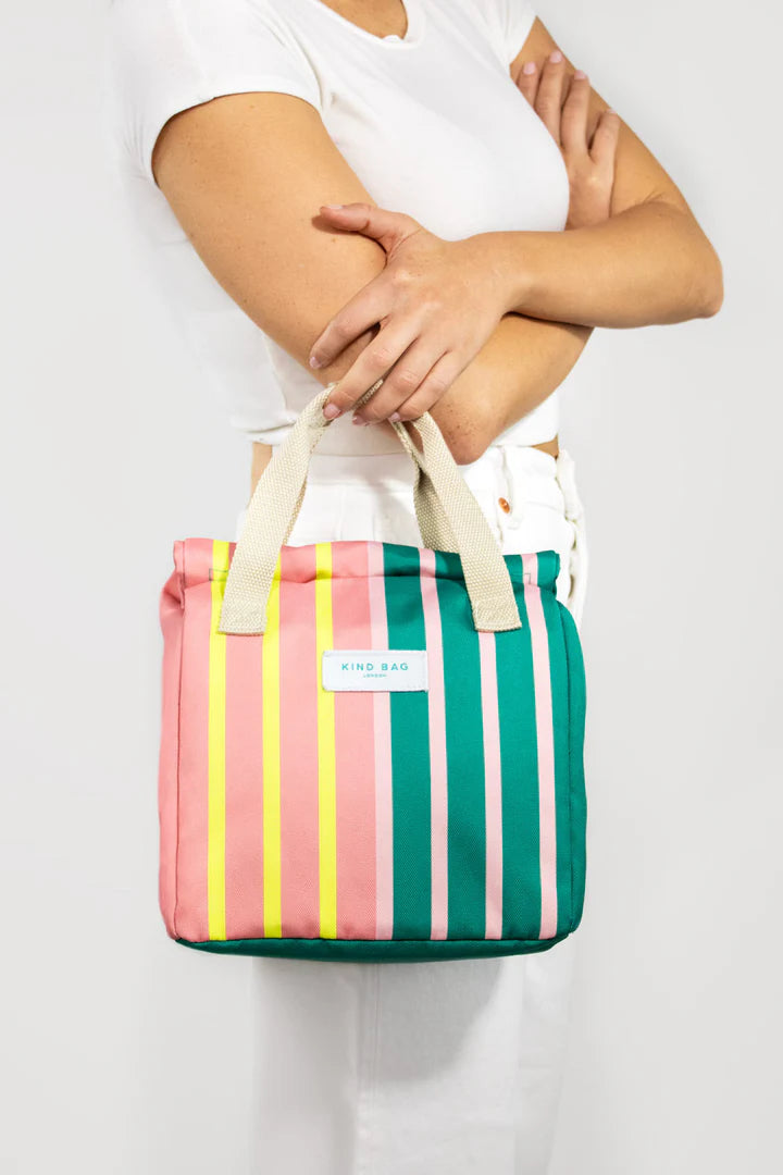 Kind Bag London striped tote bag in pink, teal, and yellow.  The bag has cream-colored handles.