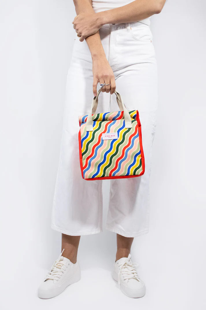 Red and multicolored wavy-patterned insulated lunch bag with beige handles.