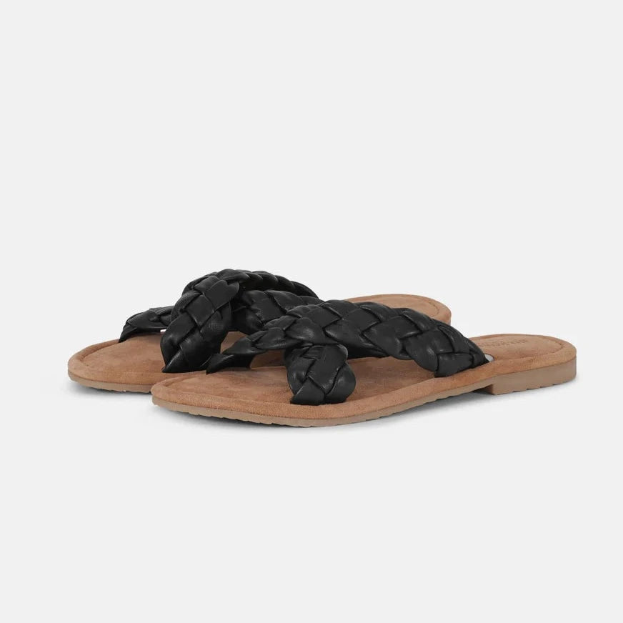 Black braided leather sandals with tan suede soles. Cross-over braided straps. Flat, casual summer footwear.
