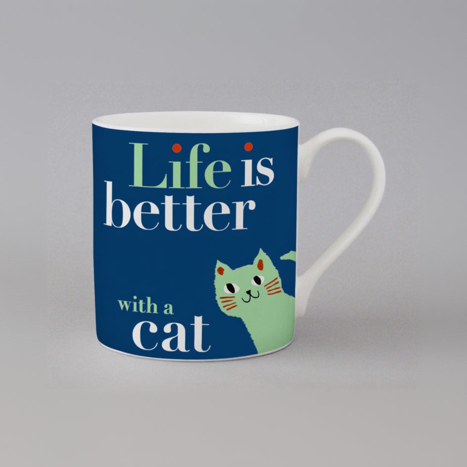 Mug with 'Life is better with a cat' text and a cat illustration on a blue background