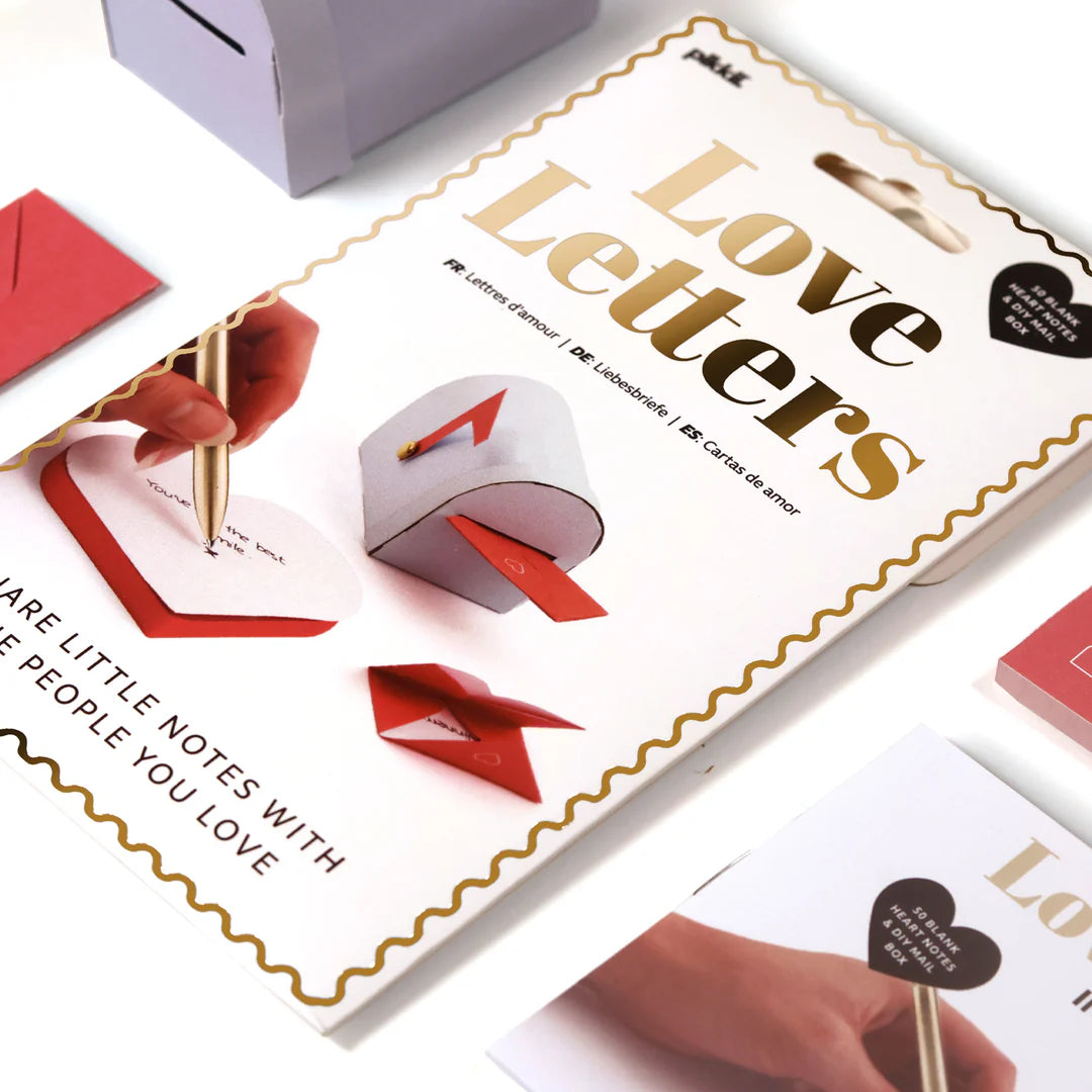 Product packaging for 'Love Letters' with red envelopes and a pen on a white background