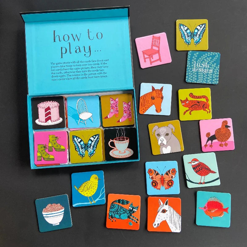 Colorful game cards with illustrations on a dark surface