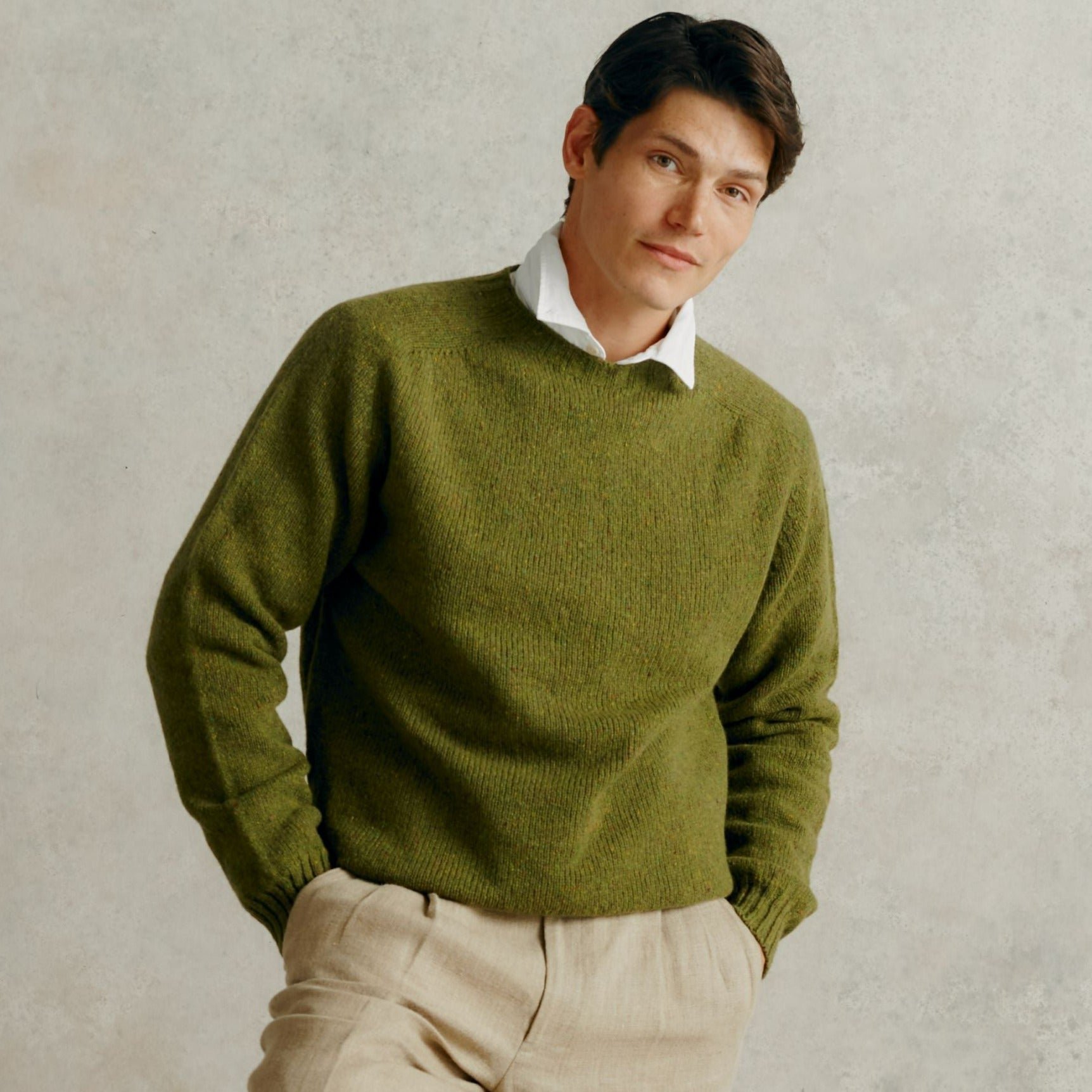 Olive green crewneck sweater with a slightly textured knit.