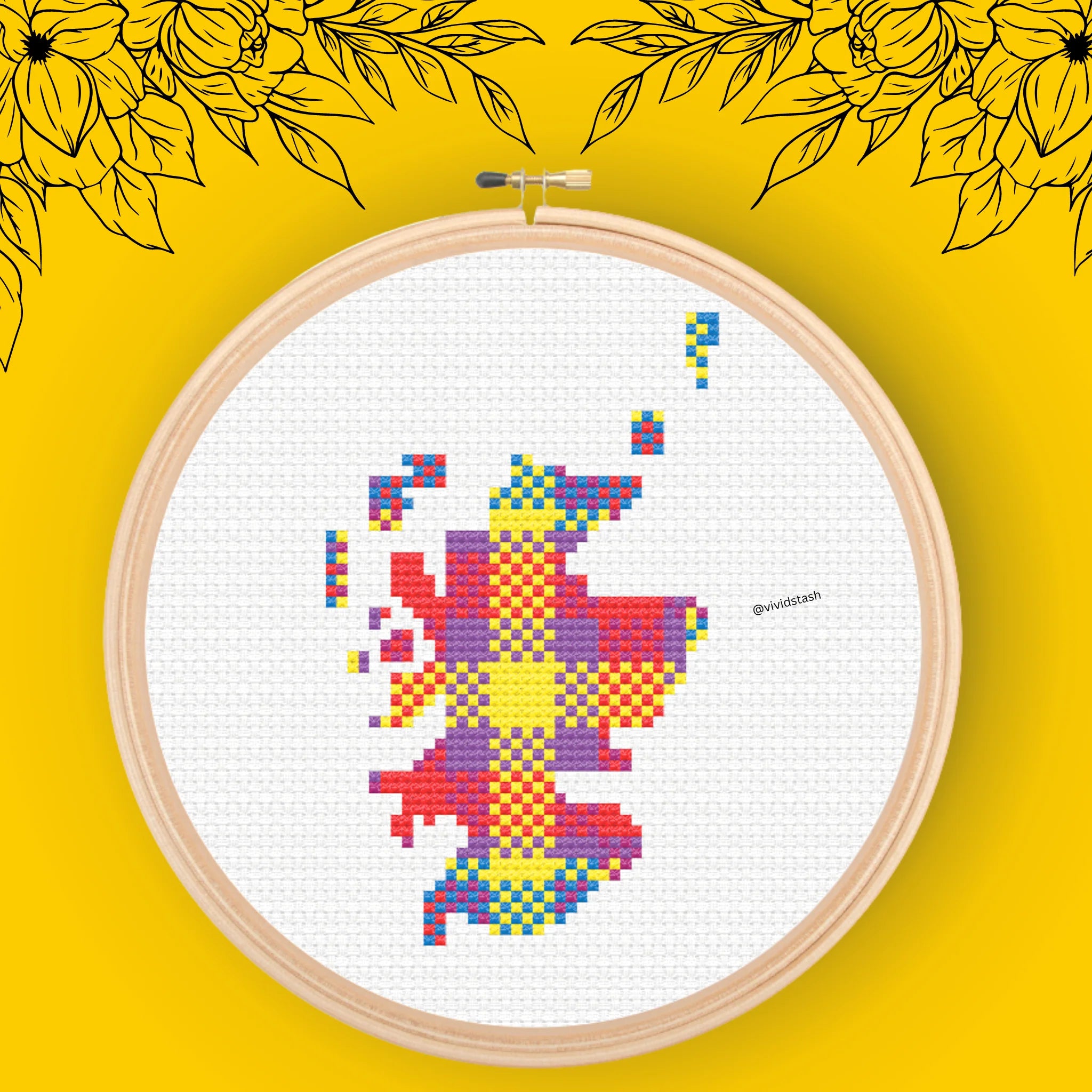 Cross-stitch embroidery of Scotland depicted in a multicolored plaid pattern on white fabric, within a wooden hoop.