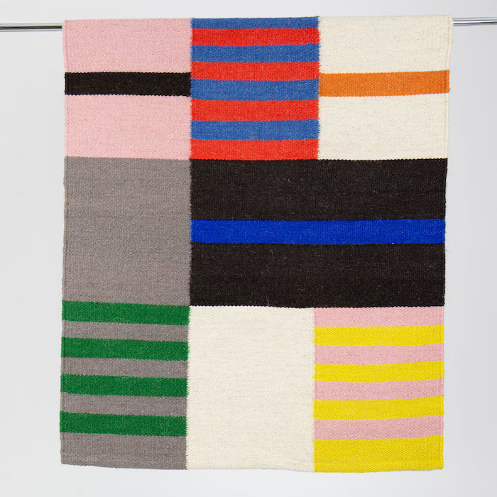Colorful striped blanket with geometric pattern on a white background