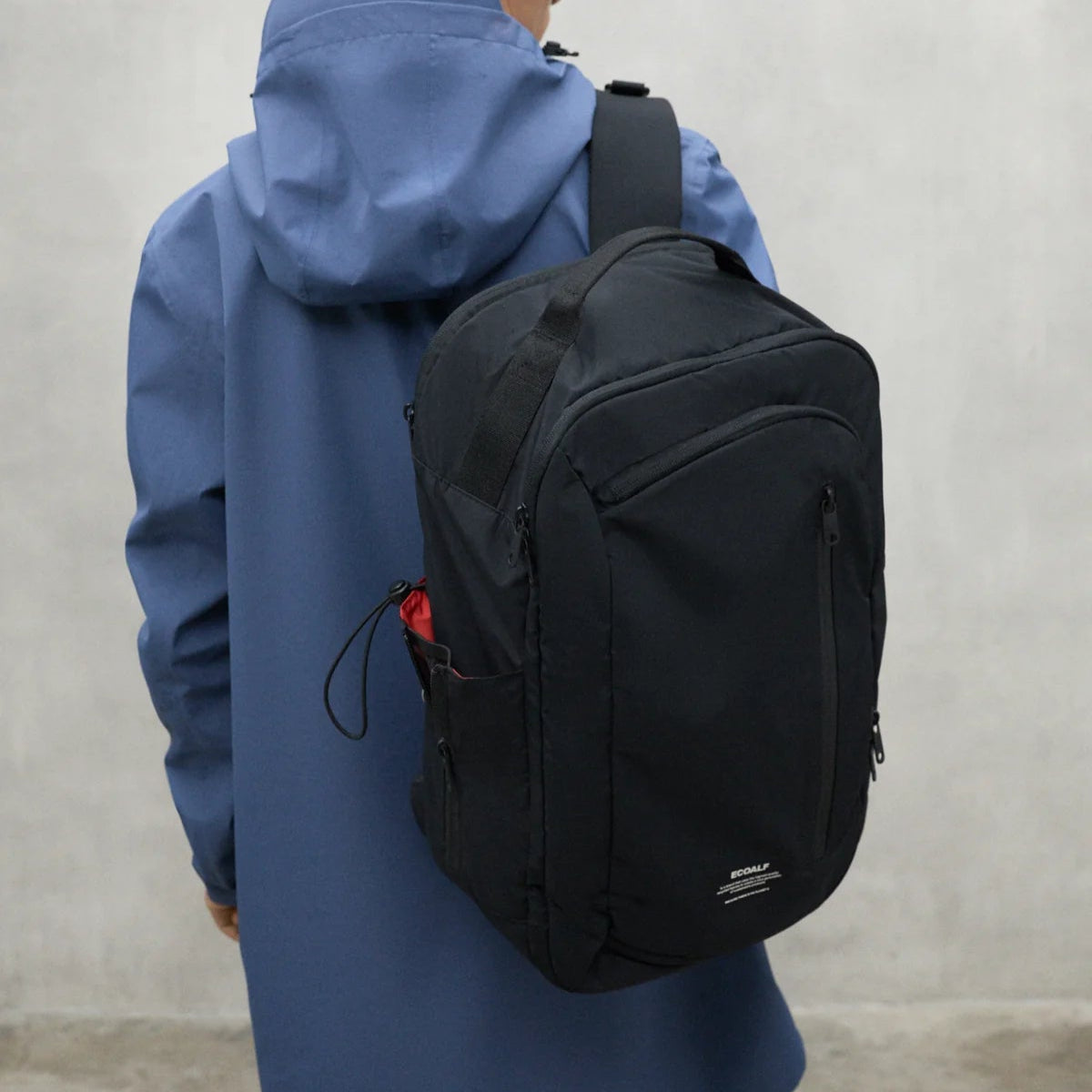 Black Ecoalf backpack with top handle and multiple compartments.