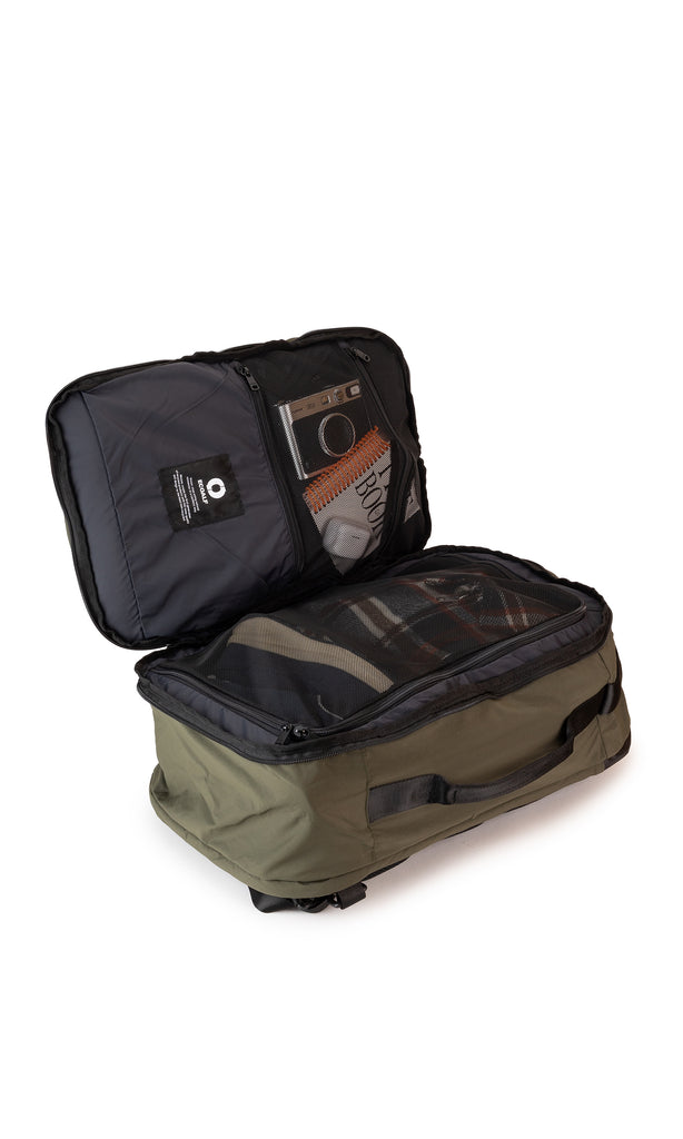 Olive green carry-on travel backpack open to reveal multiple zippered compartments and mesh pockets.