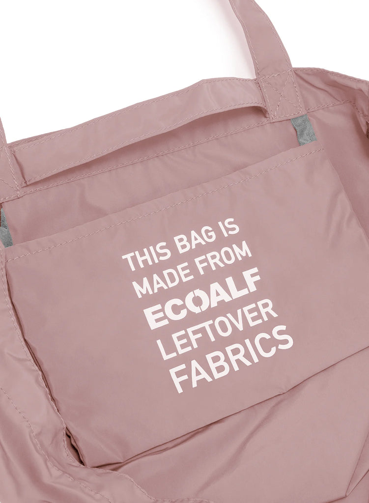 A pink Ecoalf bag featuring a text stating it's made from leftover fabrics. The interior has gray accents.
