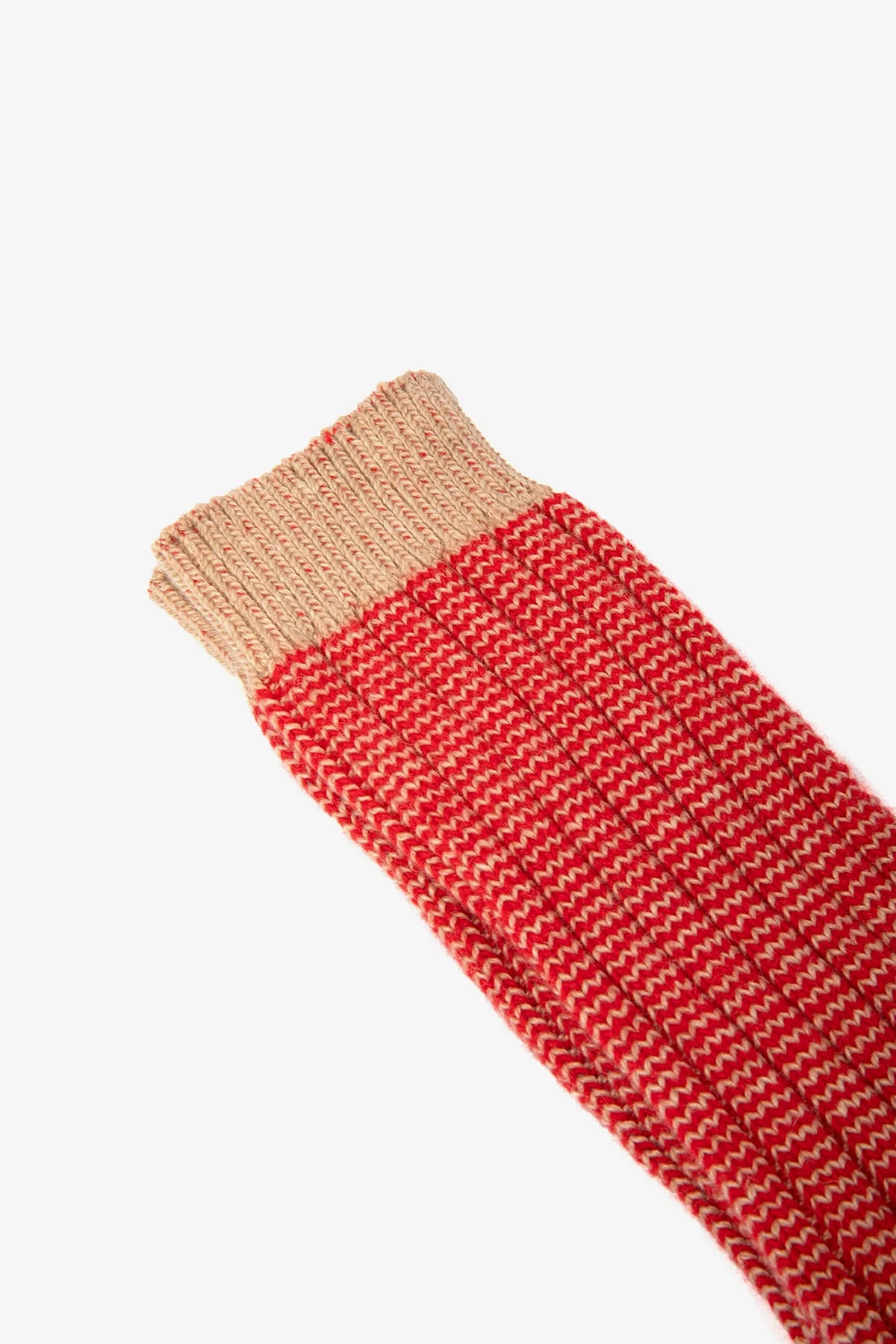Red knitted leg warm with beige top on a white background