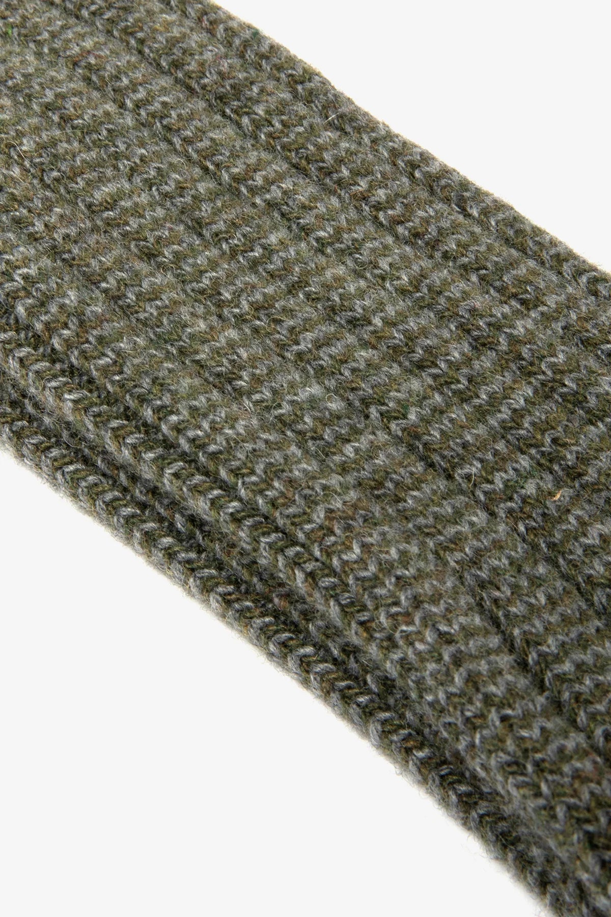Close-up of a textured green fabric strip on a white background