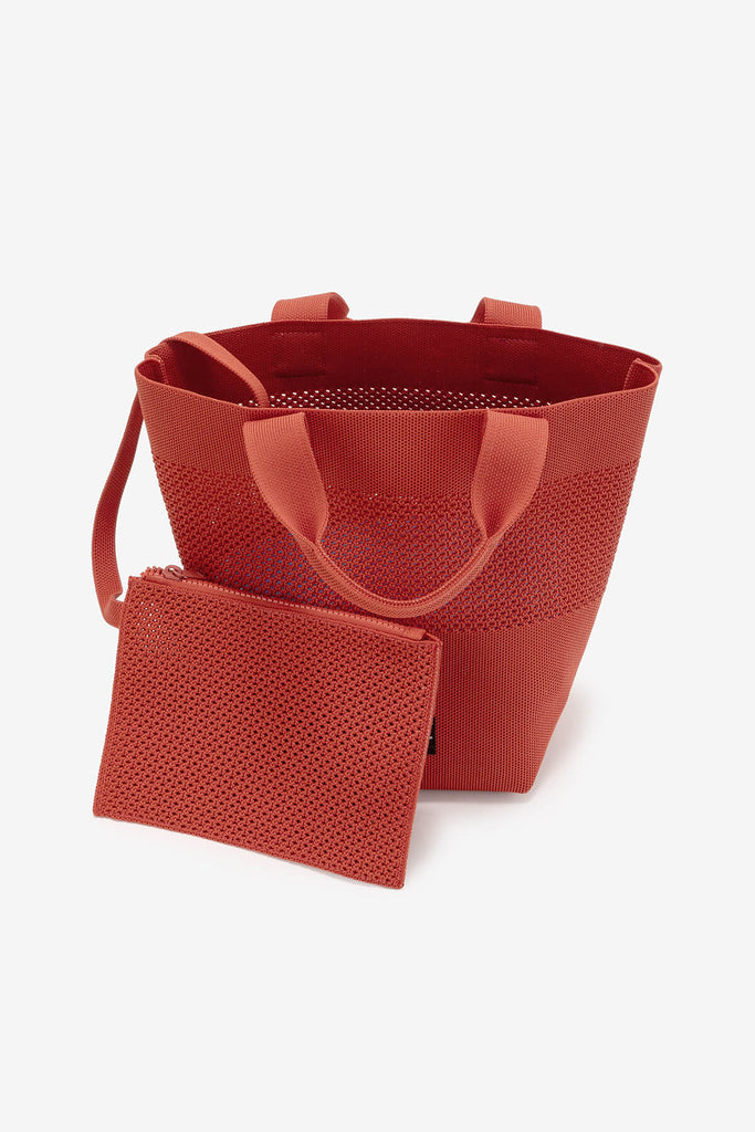 Ecoalf bag and matching pouch in a vibrant reddish-brown, featuring a stylish perforated design.