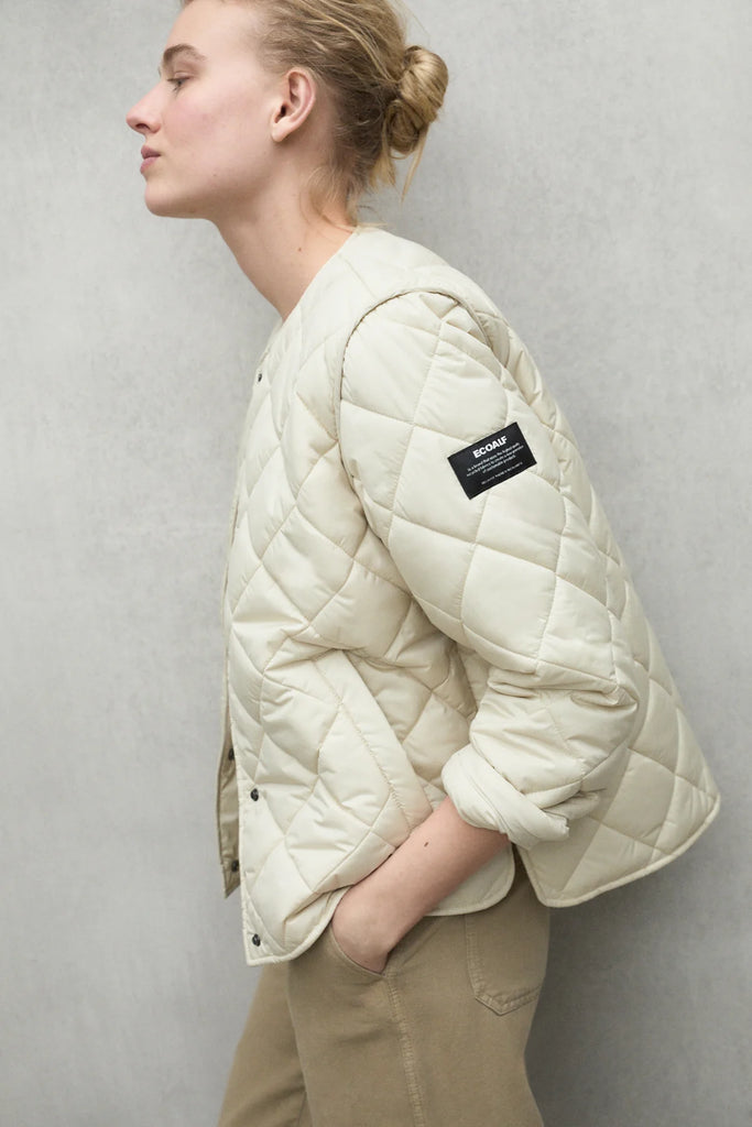 A model in a cream Ecoalf quilted jacket and beige pants poses against a neutral background.