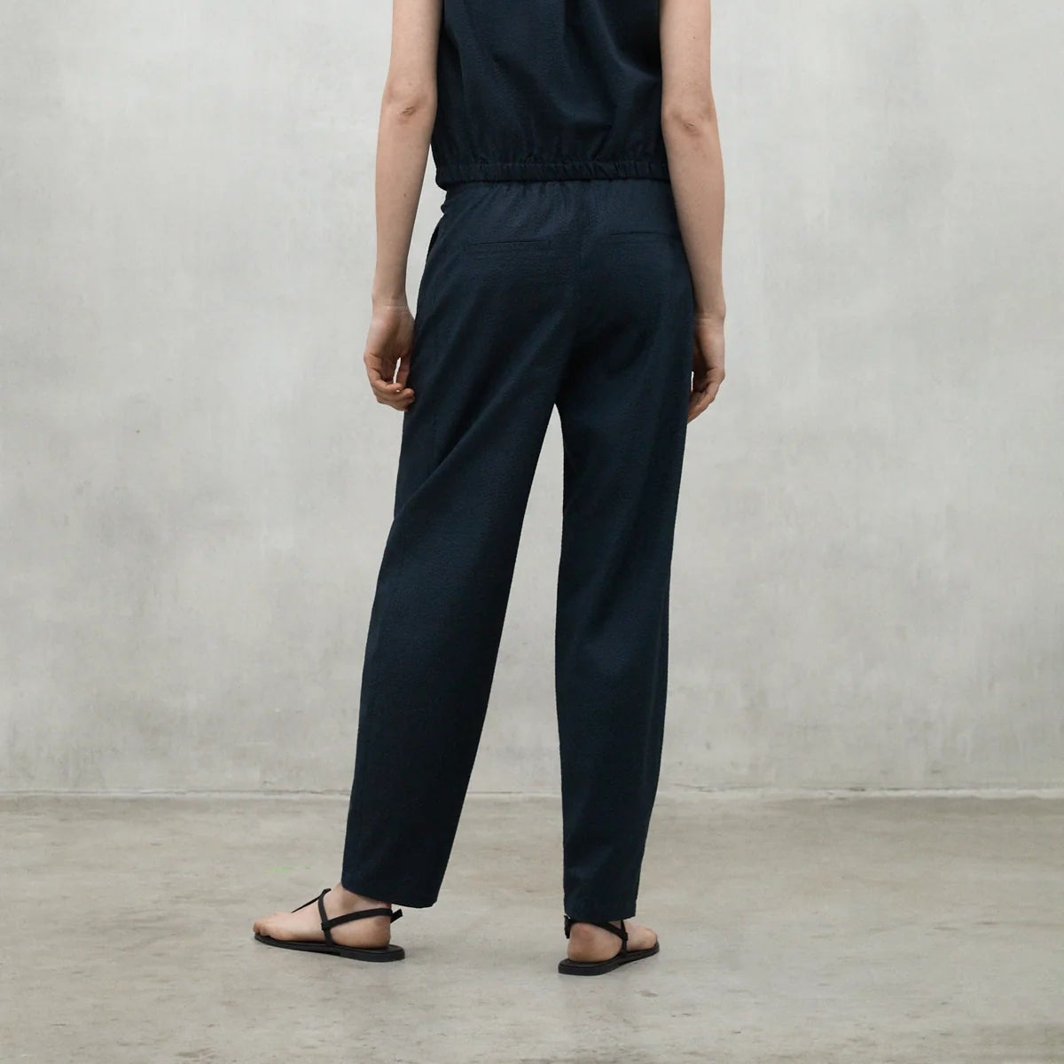 Dark teal textured wide-leg trousers with an elastic waistband.