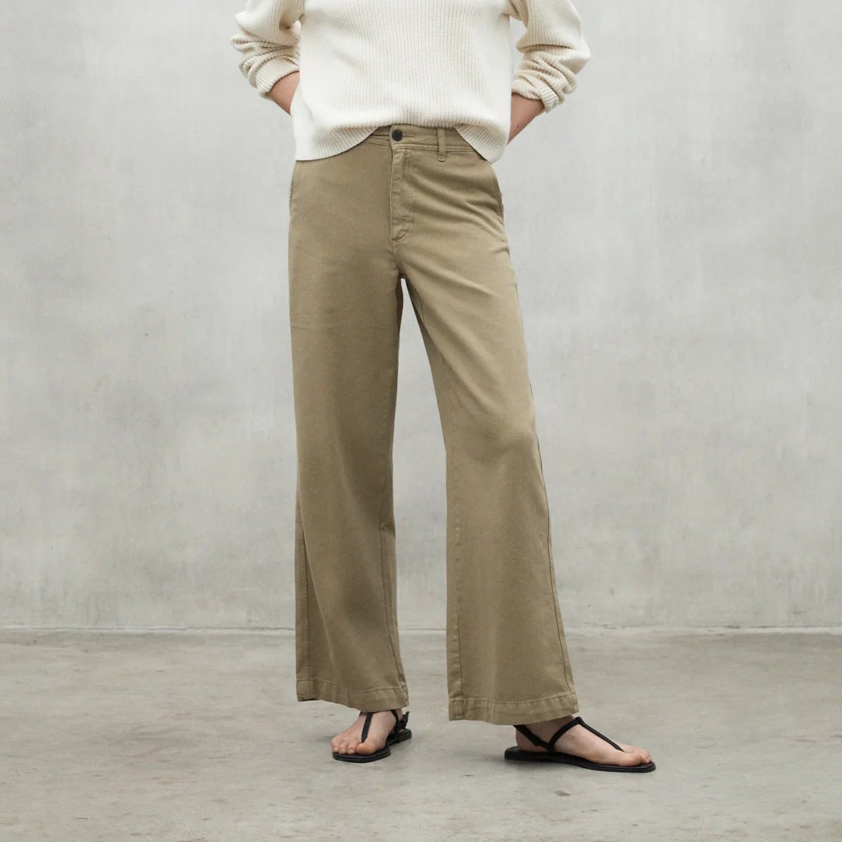 Taupe wide-leg trousers with a high waist and cuffed hems.