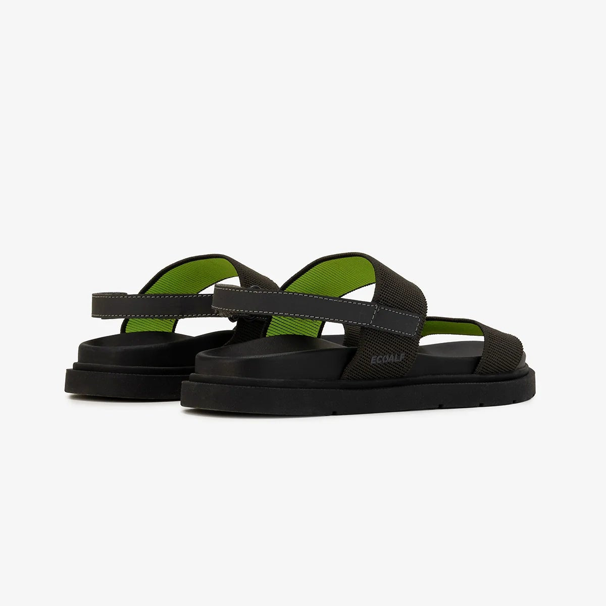 Pair of black platform sandals with lime green accents and textile straps.