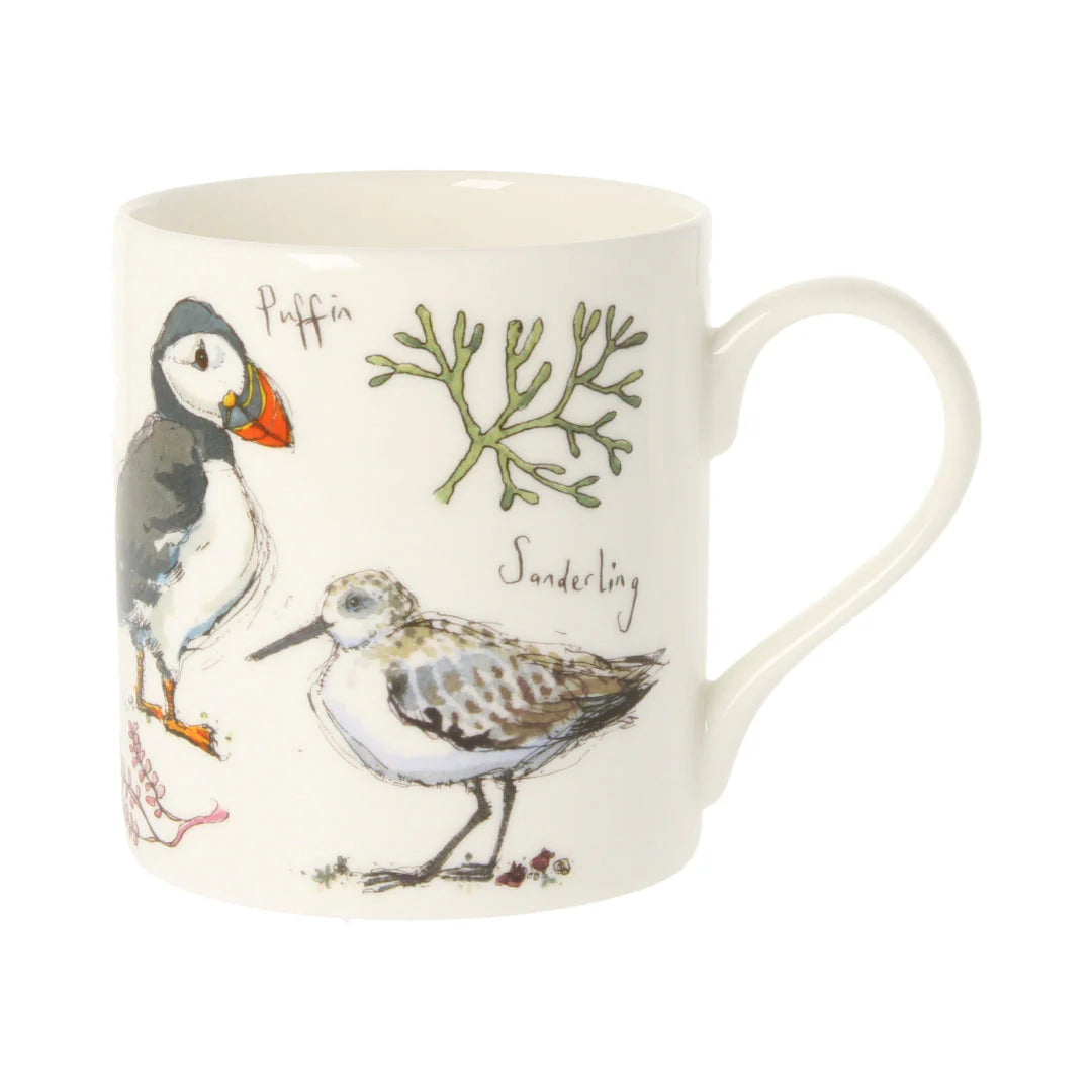 Mug with illustrations of a puffin and sandpiper, along with the words 'Puffin' and 'Sanderling'.
