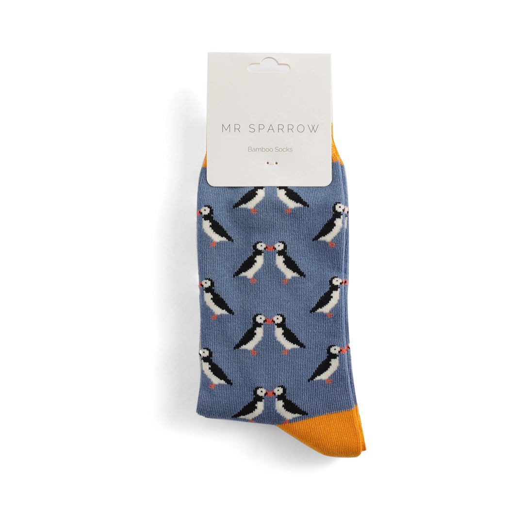 Blue bamboo socks with a repeating pattern of kissing puffins; yellow cuff.  Mr. Sparrow brand.