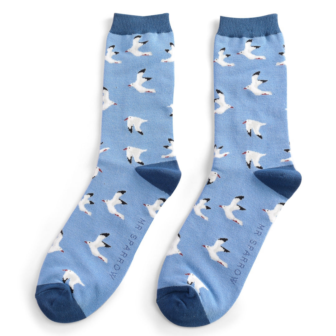 Pair of light blue crew socks featuring a repeating pattern of white seagulls in flight.